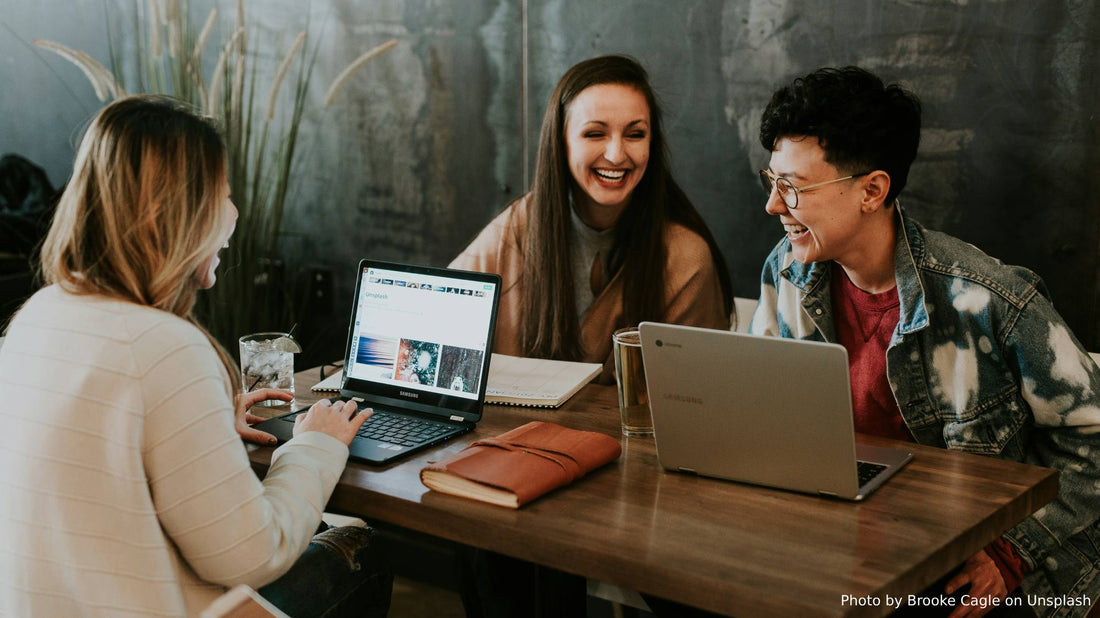 Happy office workers sitting at a table